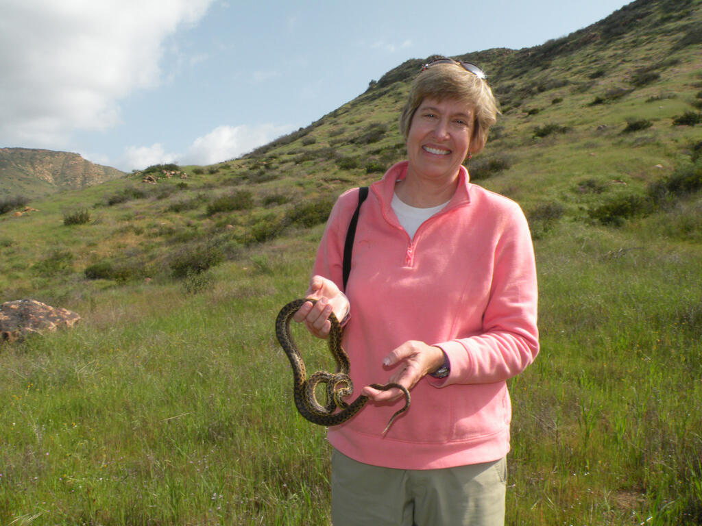 Dr. Allison Alberts sharing a moment with a gopher snake.
